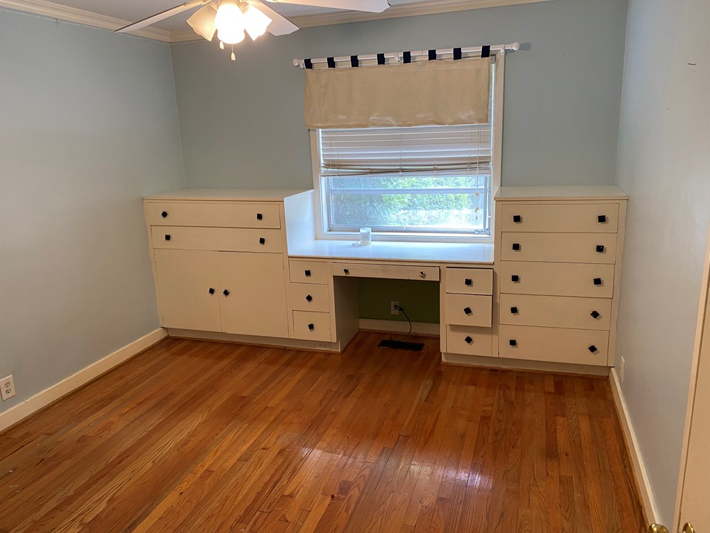 Bedroom with built in desk and cabinets